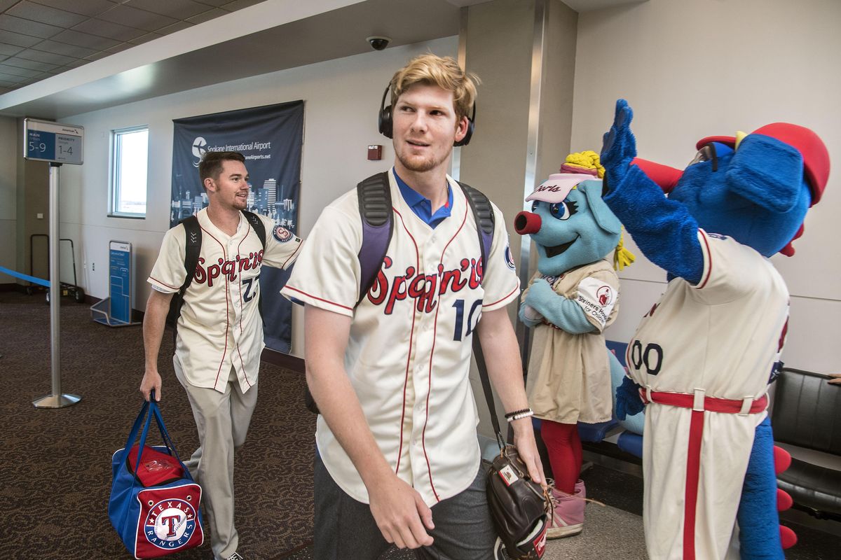 Spokane Indians pitchers, Josh Advocate, left, of Long Beach State and Noah Bremer, of U. of Washington, are greeted by Spokane Indians mascots Doris and Otto as they enter Spokane International Airport from the inaugural nonstop American Airlines Flight 599 from Dallas Fort Worth. Dan Pelle/THE SPOKESMAN-REVIEW (Dan Pelle / The Spokesman-Review)