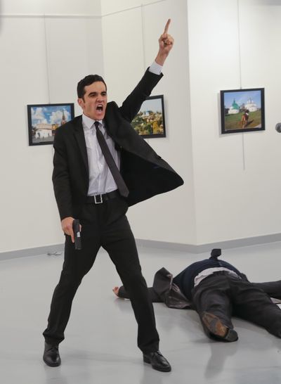 In this Monday file photo, Mevlut Mert Altintas shouts after shooting Andrei Karlov, right, the Russian ambassador to Turkey, at an art gallery in Ankara, Turkey. (Burhan Ozbilici / Associated Press)