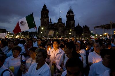 Demonstrators hold candles at Zocalo square in Mexico City. A coalition of anti-crime groups organized protest marches in all 32 Mexican states on Saturday. (Associated Press / The Spokesman-Review)