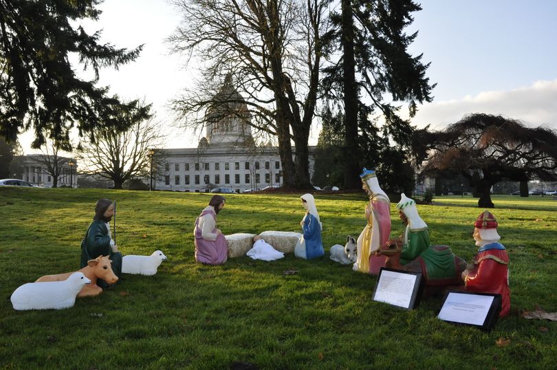 A Nativity Scene erected by Hunter Abell of Bothell, Wash., sits on the Washington State Capitol Campus about a half block from a sign put up by atheists. Both are scheduled to be up through Christmas. (Jim Camden)