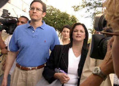 
Lea Fastow, right, faces cameras as she walks with her brother, Michael Weingarten, to the Federal Detention Center in Houston on Monday.
 (Associated Press / The Spokesman-Review)