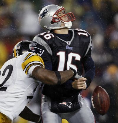 Patriots quarterback Matt Cassel has the ball stripped while being sacked by Steelers linebacker James Harrison during the third quarter of Sunday’s game at Foxborough, Mass.  (Associated Press / The Spokesman-Review)