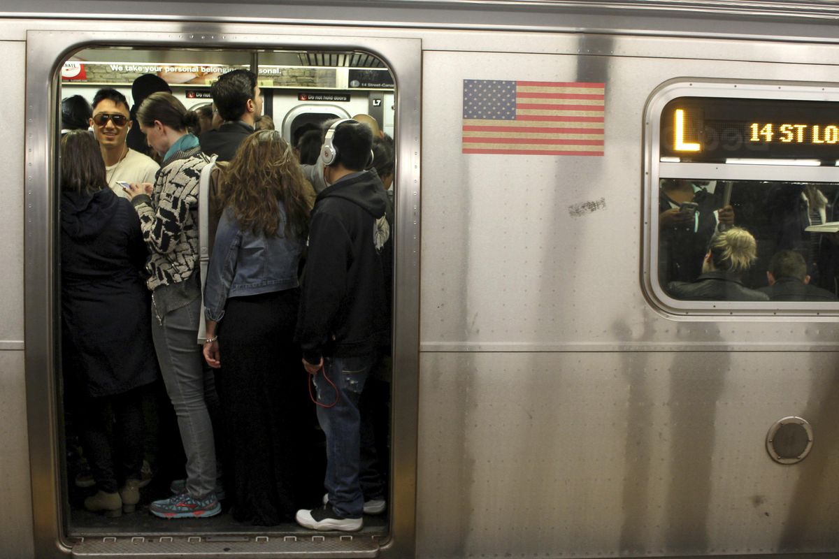 This May 5, 2016,  photo shows passengers crowd on the L Train subway in the Brooklyn borough of New York. Tourists who decide to try the subways will find them crowded, noisy and confusing, but they are the most efficient way to get around the city. (William Mathis / AP)