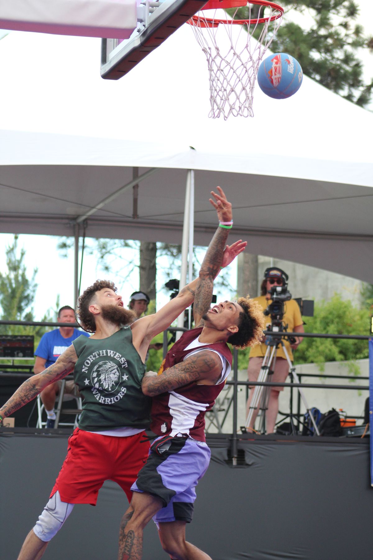 Ahbrae Harvey of the NW Warriors Elite (left) and Markieth Brown (of team Amotkan (right) contend for the ball during the Six Feet and Under championship game during Hoopfest on Sunday June 25, 2023.  (Jordan Tolley-Turner/For The Spokesman-Review)
