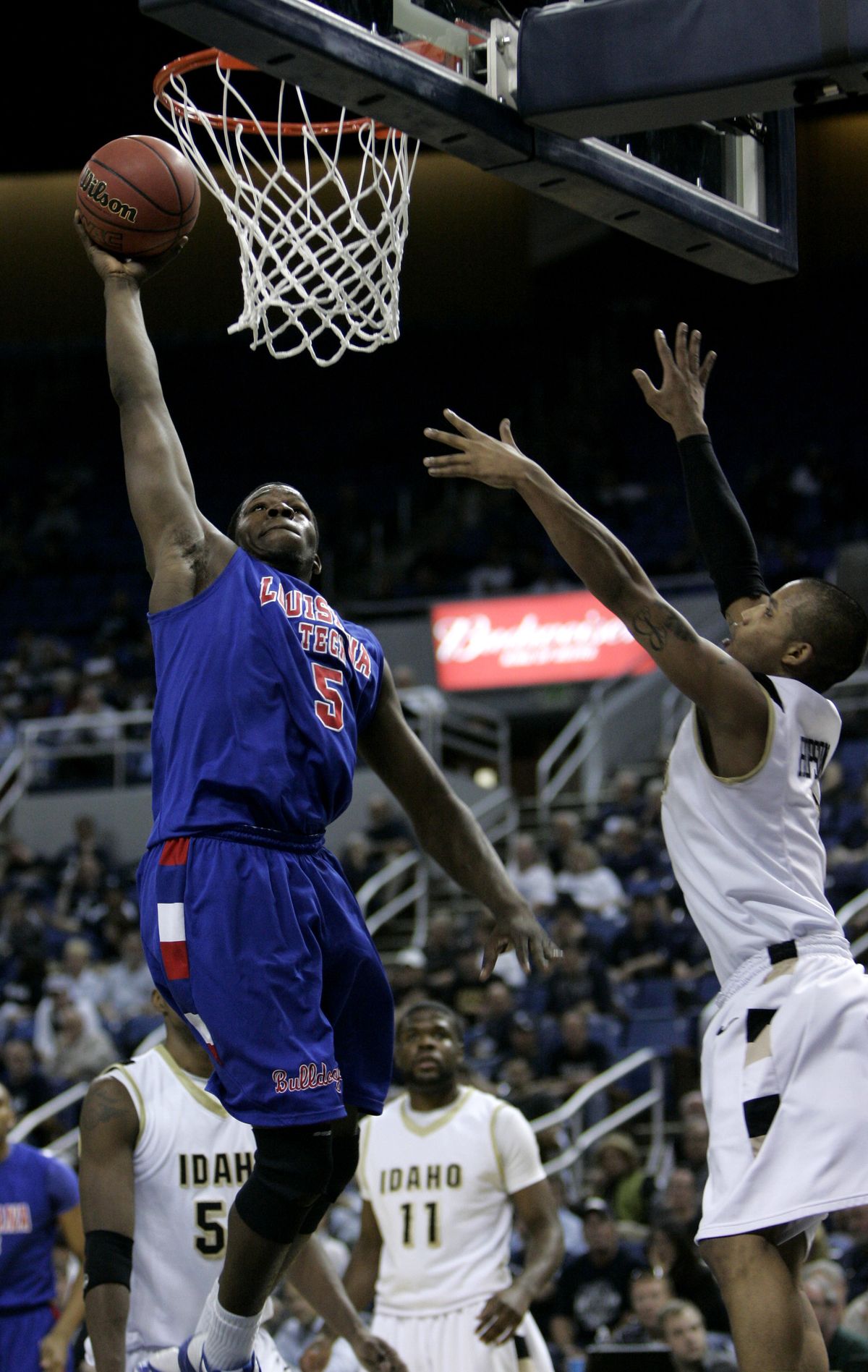 Louisiana Tech guard Olu Ashaolu, left, dunks as UI’s Mac Hopson offers resistance.  (Associated Press / The Spokesman-Review)