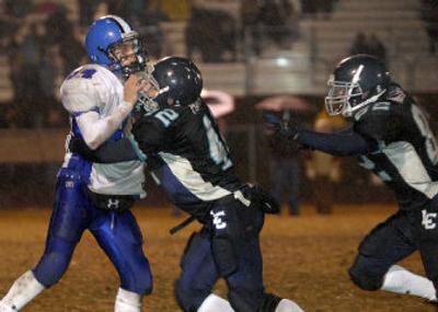 
Coeur d'Alene's Calvin Peterson, left, takes a 1-2 punch from Lake City's Christian Hanna, center, and Nick Watkins.
 (Jesse Tinsley / The Spokesman-Review)
