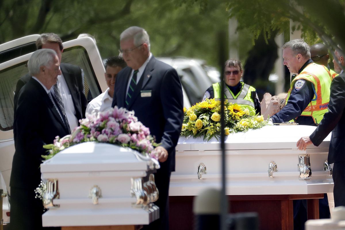 The caskets of family members who were killed in a flash flood are loaded into hearses outside St. Patrick Catholic Church, Tuesday, July 25, 2017, in Scottsdale, Ariz. Ten members of an extended Arizona family were killed earlier this month in flash flood while they celebrated a birthday. (Matt York / Associated Press)