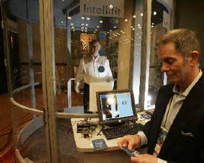 
David Aune, left, gets measured at the Intellifit kiosk by Ed Gribbin, president of Intellifit, at the DEMO technology conference.
 (Associated Press / The Spokesman-Review)