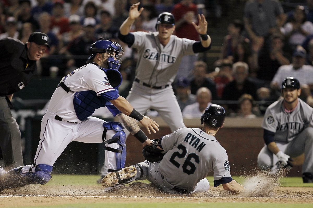 Rangers catcher Mike Napoli tags out Brendan Ryan at the plate, denying the Mariner of an inside-the-park home run in the eighth inning. (Associated Press)