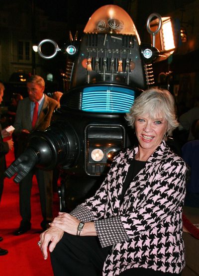 This Nov.8,2006, file photo supplied by Warner Home Video shows actress Anne Francis posing with Robby the Robot at a  screening to commemorate the 50th anniversary  of the film, 