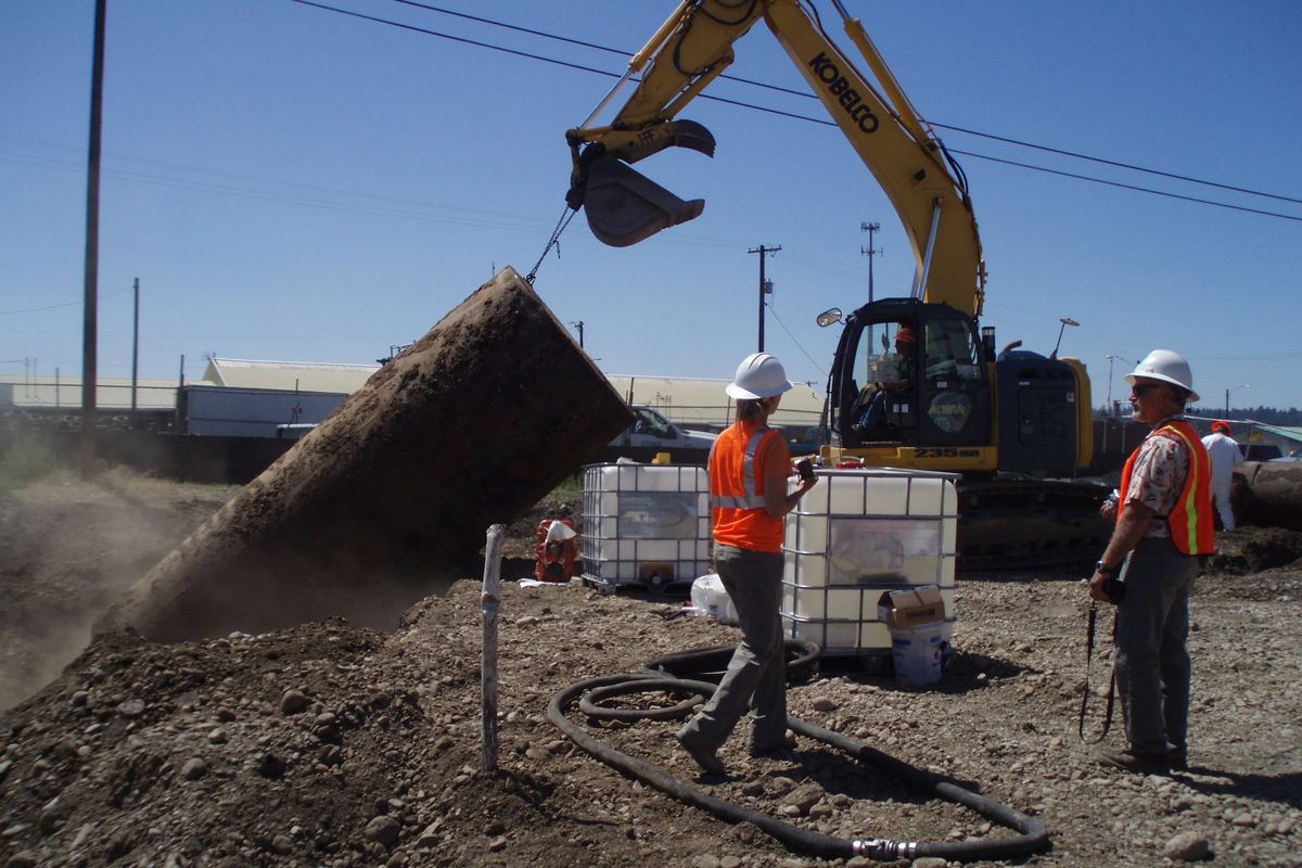 A contractor and Department of Ecology TCP co-project manager, Bill Fees, are at the site of a tank removal. More than 8,200 tons of PCB-laden material was removed over the summer at City Parcel in Spokane.
 (Department of Ecology)