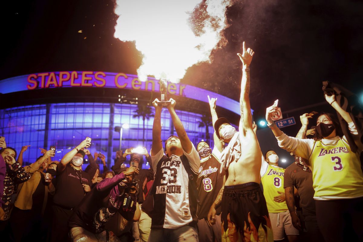Los Angeles Lakers fans celebrate outside of Staples Center, Sunday, Oct. 11, 2020, in Los Angeles, after the Lakers defeated the Miami Heat in Game 6 of basketball
