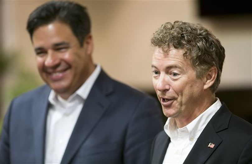 Kentucky Sen. Rand Paul, right, takes questions from reporters in Boise on Thursday; at left is Idaho Rep. Raul Labrador (AP/Idaho Statesman / Kyle Green)