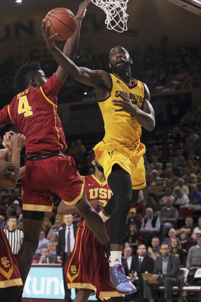 Arizona State forward Obinna Oleka, right, goes up to the basket against Southern California forward Chimezie Metu during the first half of Friday’s game in Tempe, Ariz. (Ricardo Arduengo / Associated Press)