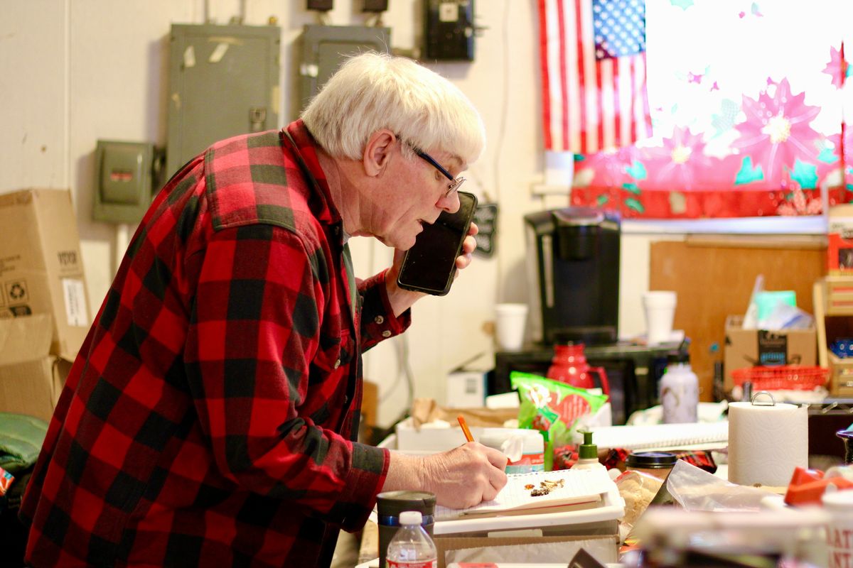 Charles Omit takes a phone call from a local resident wanting to donate her cabinet on Friday. Omit has been running Operation Santa, a community store in Kettle Falls, for about 12 years now. (Monica Carrillo-Casas/The Spokesman-Review)