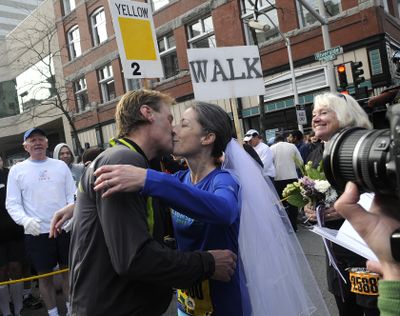Right, Maid of honor, Dawn Fall, watches as Michael Smith and Karen Fall seal their nuptial's with a kiss before Bloomsday on Sunday, May 1, 2011. (Bart Rayniak / The Spokesman-Review)