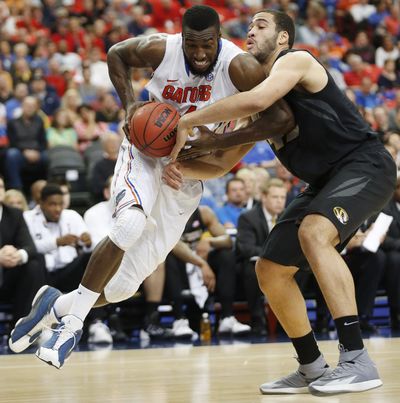Center Patric Young, left, helped the Florida Gators break through the Elite Eight after three failed tries. (Associated Press)