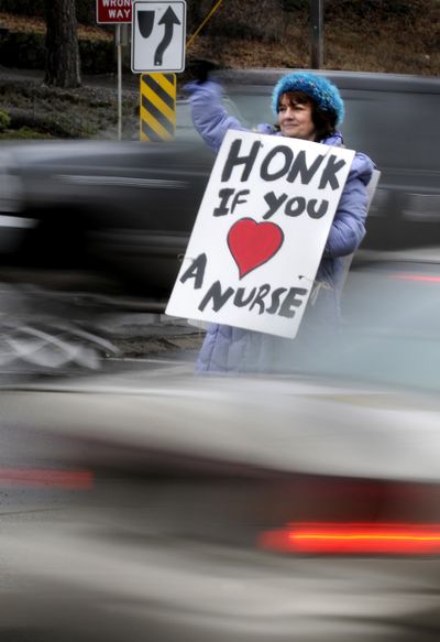 Barb Ormsby, a cardiac nurse for 23 years at Providence Sacred Heart Medical Center, joined dozens of nurses on South McClellan Street to protest the hospital’s new workplace rules. (Colin Mulvany)