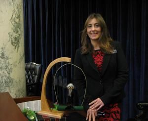 Rep. Heather Scott, R-Blanchard, poses with the "crow" at her desk in the Idaho House chamber (Betsy Z. Russell)