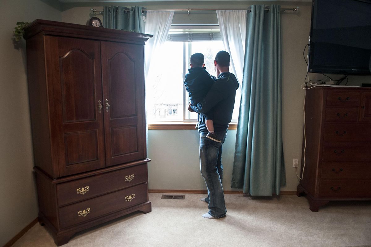 Maverick Shimic Jr., 2 and his dad, Maverick, check out the view from the master bedroom during an open house tour of a home for sale through Realty One Group Eclipse in Spokane Valley on Saturday, April, 13, 2019. (Kathy Plonka / The Spokesman-Review)