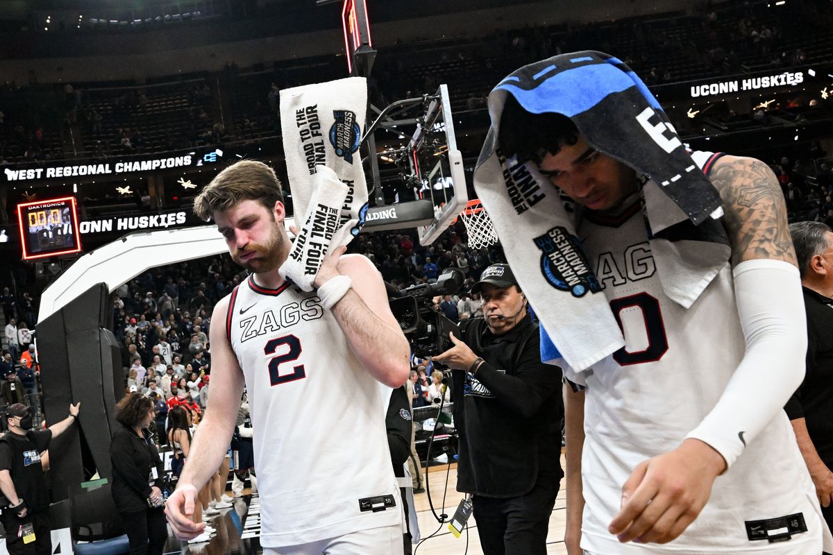Gonzaga Bulldogs forward Drew Timme (2) swings a towel and exhales as he leaves the court with guard Julian Strawther (0) after runaway loss in an NCAA Tournament Elite 8 basketball game against UConnon on Saturday, March 25, 2023, at T-Mobile Arena in Las Vegas, Nev. UConn held Timme and Strawther to 12 and 11 points respectively and won the game 82-54.  (Tyler Tjomsland/The Spokesman-Review)