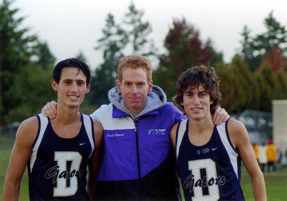 Now: Darryl Genest, center, with two club team runners he coaches in Federal Way. (Courtesy Family / The Spokesman-Review)