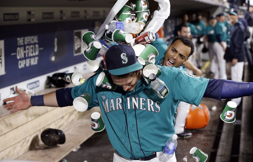 Seattle Mariners’ Logan Morrison is showered with garbage by Nelson Cruz after hitting the winning home run on Friday. (Associated Press)