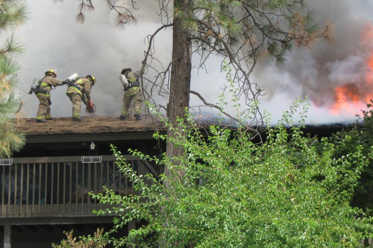 Spokane Valley firefighters work to put out a house fire in the 2500 block of South Timberlane Drive on Sept. 16, 2011. The fire caused $300,000 in damage. (Photo courtesy the Spokane Valley Fire Department)