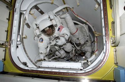 
Astronauts Daniel Bursch, left, and Carl E. Walz are seen in the crew lock of the Quest module prior to spacewalking from the International Space Station in February 2002.
 (Associated Press / The Spokesman-Review)