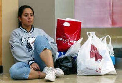 
A shopper takes a break from holiday shopping recently in Mesa, Ariz. Consumers were stingier than usual this shopping season, analysts said.
 (Associated Press / The Spokesman-Review)