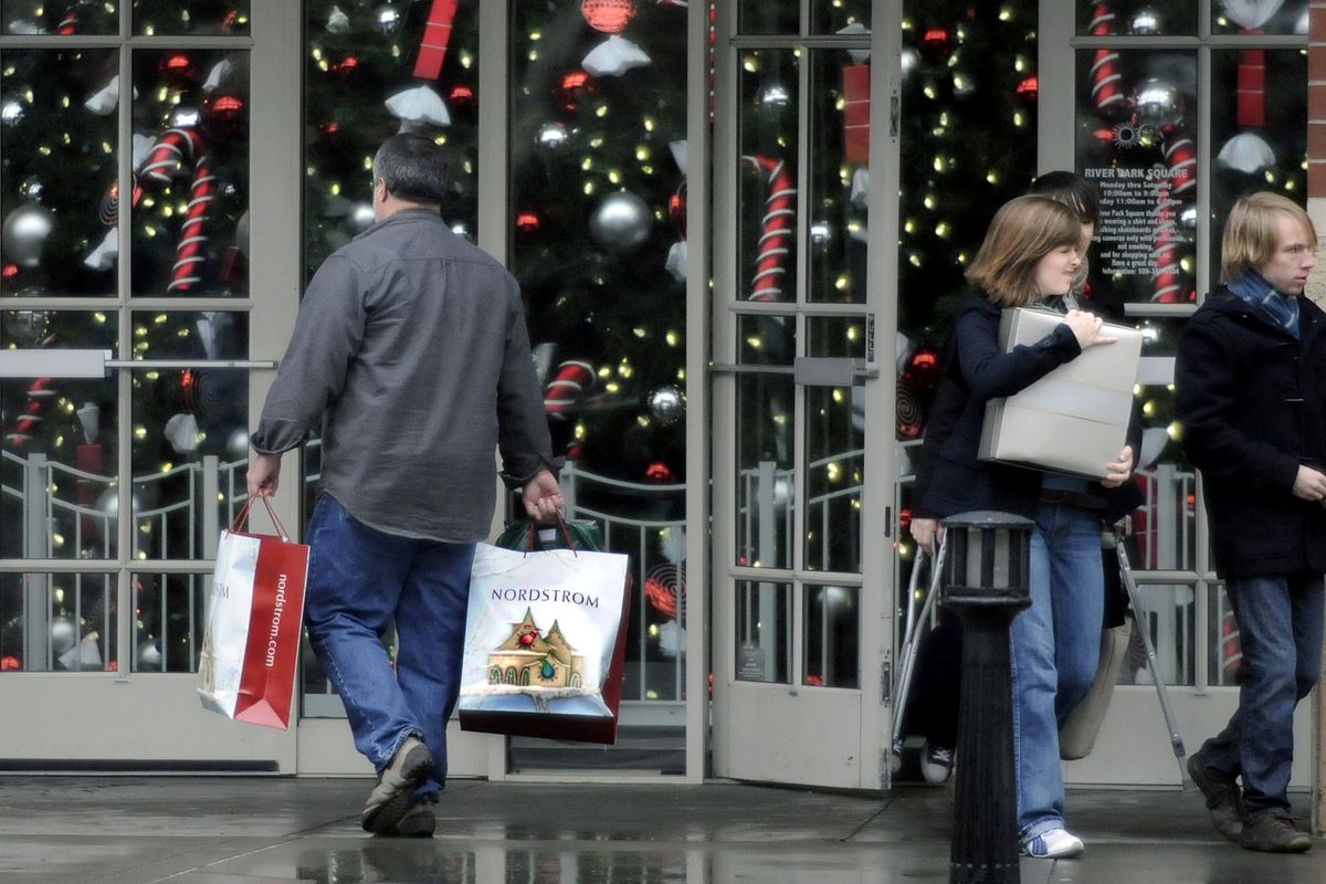 Shoppers make their way in and out of River Park Square in downtown Spokane with packages and bags on Saturday, the last Saturday before Christmas.