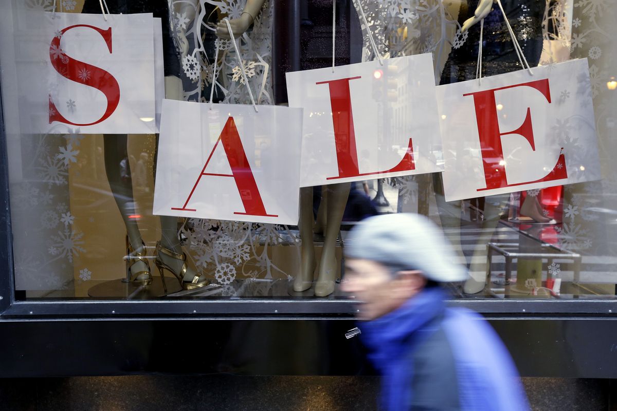 In this Tuesday, Dec. 18, 2012, photo, a person passes a retail store with sale sign displayed in the window in Philadelphia. When it comes to big discounts, better late than never. This holiday shopping season, stores haven�t been offering the same big discounts as they did in previous years as they tried to lure shoppers in with other incentives,but during the final days leading up to Christmas, shoppers will see more of those jaw-dropping �70 percent off� sale signs as stores try to salvage a season that so far has been disappointing. (Matt Rourke / Associated Press)