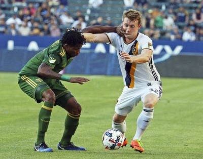 Portland Timbers defender Alvas Powell (2) puts a hand to the face of LA Galaxy forward Jack McBean (32) during the second half of an MLS soccer match in Carson, Calif., Sunday, March 12, 2017. The Timbers won 1-0. (Reed Saxon / Associated Press)