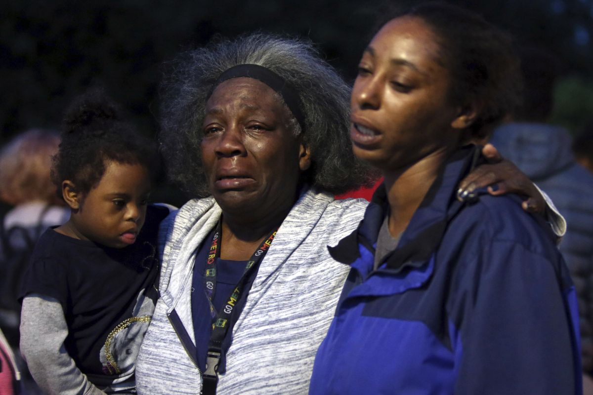 Charleena Lyles’ aunt Laurie Davis and oldest sister Monika Williams hold each other as several dozen people attend a vigil outside the Seattle apartment building where Charleena Lyles lived, Sunday, June 18, 2017. Seattle police are investigating the fatal shooting by two officers of the woman family members say was pregnant and struggling with mental health issues. (Genna Martin / seattlepi.com)