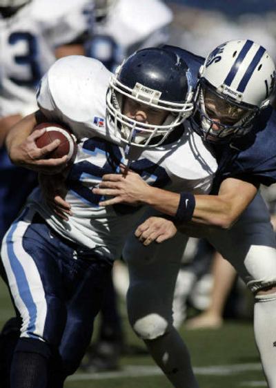 
Conor Hare breaks the tackle of Bellarmine's Austin Hoberg to score one of the Gonzaga Prep senior's three touchdowns in the Bullpups' 26-0 win. 
 (Associated Press / The Spokesman-Review)