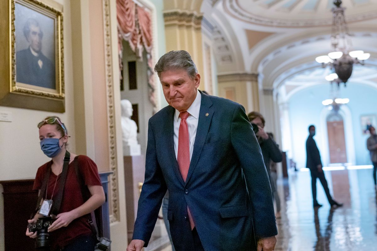 FILE - Sen. Joe Manchin, D-W.Va., walks to a caucus lunch at the Capitol in Washington, Dec. 17, 2021. Manchin said Sunday, Dec. 19, 2021 he cannot back a $2 trillion social safety net bill, dealing a potentially fatal blow to President Joe Biden’s signature legislation. (J. Scott Applewhite)