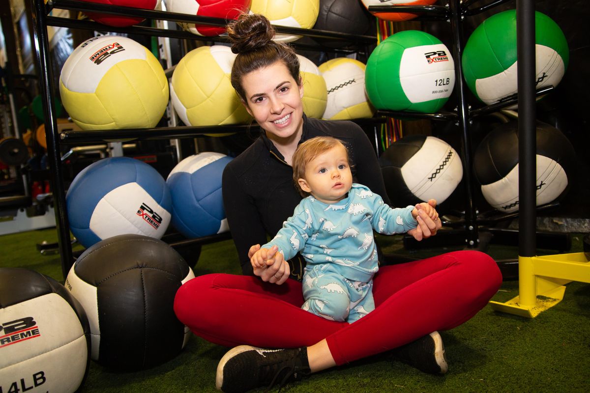 Angela Rypien poses with her 11-month-old son Mekhi Miller at Premier Sports in Post Falls on Monday, March 11, 2019. Rypien is the daughter of former NFL quarterback Mark Rypien, and has started a Fit4Mom fitness business that aims to keep prenatal and postpartum moms get and stay fit, through classes like Stroller Strides, Body Back and Stroller Barre. (Libby Kamrowski / The Spokesman-Review)