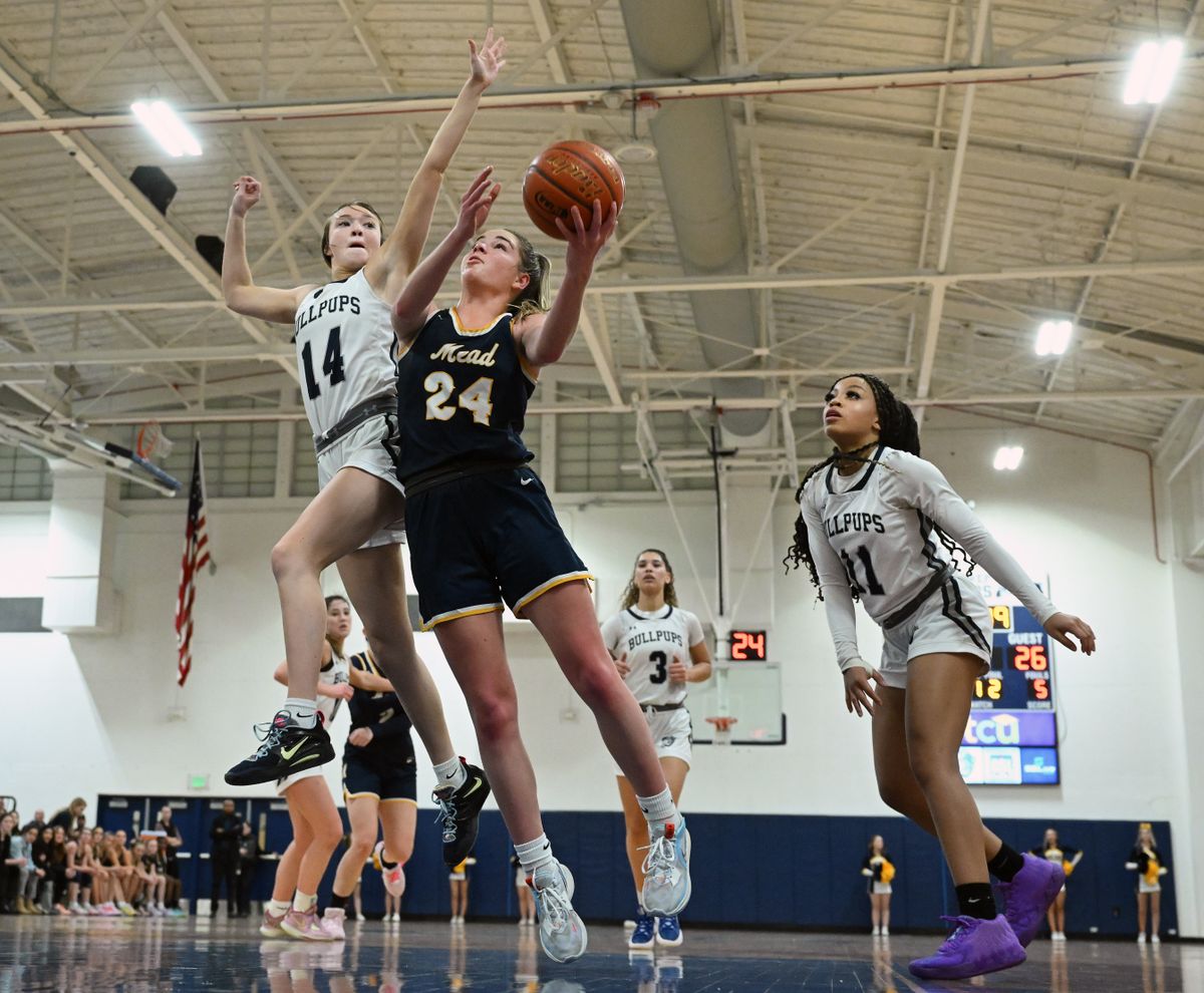 Gonzaga Prep guard Rhyan Madden (14) defends against a shot by Mead guard Teryn Gardner (24) on Tuesday at Gonzaga Prep. (Colin Mulvany/The Spokesman-Review)