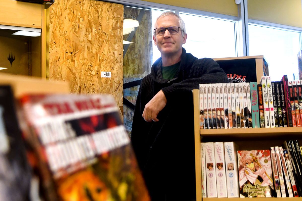 Craig Barnett, owner of The Comic Book Shop, stands Friday in front of the broken window of his business after thieves recently stole $30,000 worth of merchandise.  (Kathy Plonka/The Spokesman-Review)