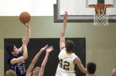 
Coeur d'Alene's Nate Bligh #22 shoots over Lakeland's Phillip Viebrock #10, and Ben Ward #42 Thursday night at Lakeland High school. The Vikings went on to win.
 (Tom Davenport/ / The Spokesman-Review)