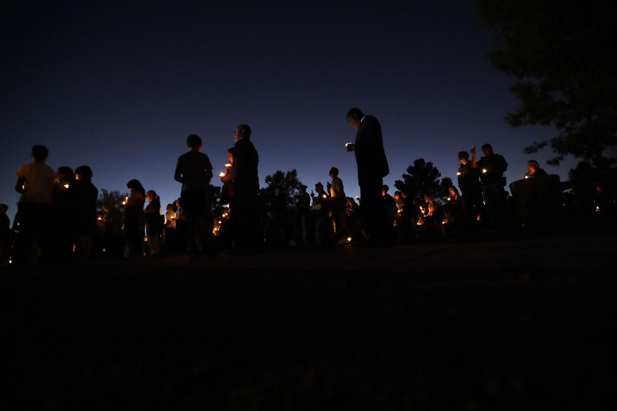 People hold candles during a vigil in honor of Las Vegas police officer Charleston Hartfield Thursday, Oct. 5, 2017, in Las Vegas. Hartfield was killed during the Sunday night mass shooting at the Route 91 Harvest country music festival. (AP Photo/Gregory Bull) ORG XMIT: NVGB101 (Gregory Bull / Associated Press photos)
