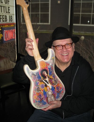 Doug Clark poses with a Stratocaster guitar.