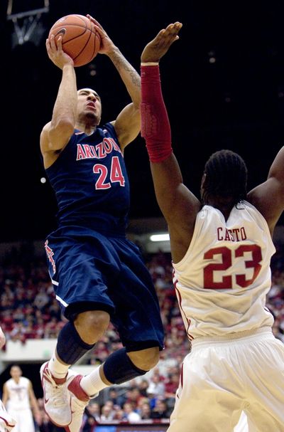 Arizona guard Brendon Lavender shoots over DeAngelo Casto of WSU during the first half of Saturday’s game. (Associated Press)