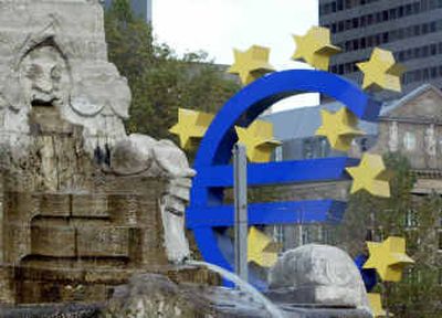 
The euro sculpture is seen beside a fountain at the European Central Bank in Frankfurt, Germany, on Friday. 
 (Associated Press / The Spokesman-Review)