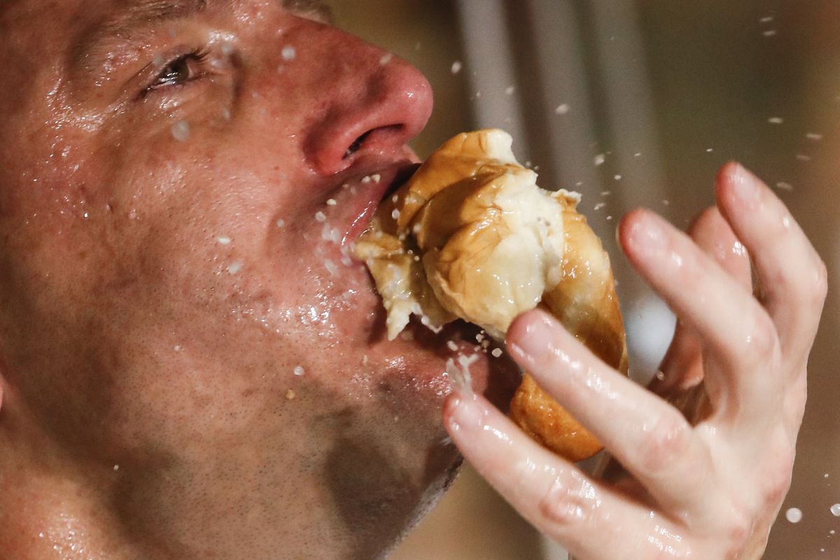 Joey Chestnut sets a world record to win the Nathan’s Famous Hot Dog Eating Contest on Saturday in New York.  (John Minchillo)