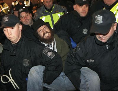 Police remove an Occupy Boston protester from Dewey Square before dawn on Saturday. More than 40 people were peacefully arrested as the park was cleared. (Associated Press)