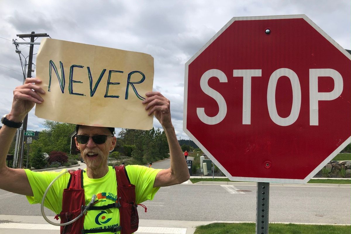 John Harris holds up a sign during a run with Fleet Feet Spokane in May 2020.  (Courtesy Kathryn Harris)