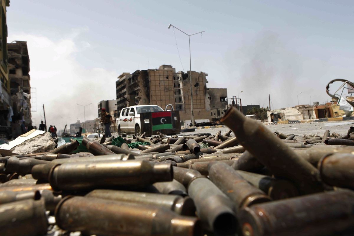 Bullet casings litter a street in Misrata, Libya, on Saturday. Government troops retreated to the outskirts of the western city under rebel fire Saturday. (Associated Press)