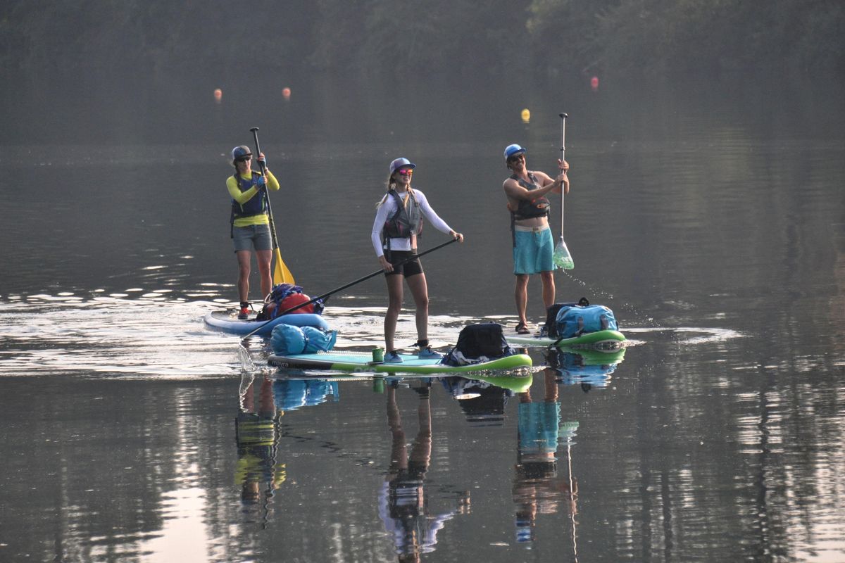 Grace Robison, Allison Roskelley and Jed Conklin navigate their SUPs on a flatwater stretch of the Spokane River on Aug. 5, 2017, during a four-day trip to paddle the entire 112 miles of the river. (Rich Landers / The Spokesman-Review)