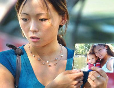 
Melinda Duckett, mother of missing 2-year-old Trenton Duckett, holds a picture of her and her son following a news conference at the Leesburg, Fla., Police Department late last month. 
 (Associated Press / The Spokesman-Review)